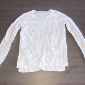 White sweater, pattern on each side of front.